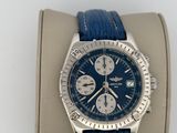 the watch is blue and has a silver case and a blue strap