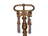 a gold candle holder with tassels hanging from it