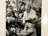 black and white photograph of a man working in a workshop