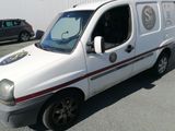 a small white van parked in a parking lot