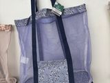 a bag hanging on the wall next to a pair of boots