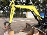a yellow excavator that is sitting in the dirt