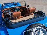 a blue car with a brown leather seat and steering