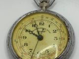 a silver pocket watch with a chain on a white surface