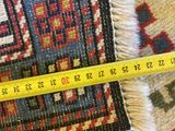 a close up of a rug with a measuring tape on top of it