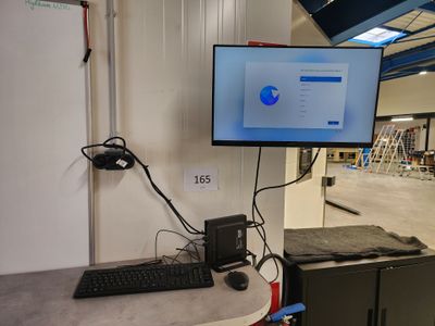 a computer monitor and keyboard on a desk in a room
