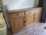 a wooden cabinet with drawers and drawers on it
