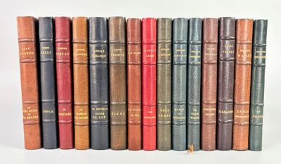 several old books are lined up in a row on a white surface