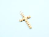 gold cross charm on a blue background