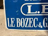 a blue and white sign sitting on the side of the road