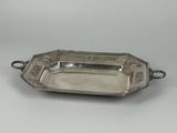 a silver plate with a handle and a handle on it