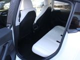 a white car with black seats in the back of it