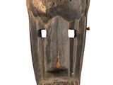 an image of a wooden mask with horns on a white background