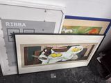 two framed pictures of a cat and a bird on a table