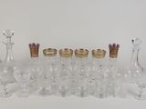 a lot of glasses and vases sitting on a table