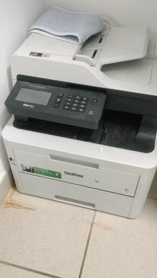 a white printer sitting on top of a white cabinet