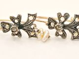 two pairs of earrings with pearls and a cross on them