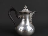 an antique silver coffee pot on a black background with a black background
