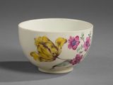 a white bowl with yellow and pink flowers on it