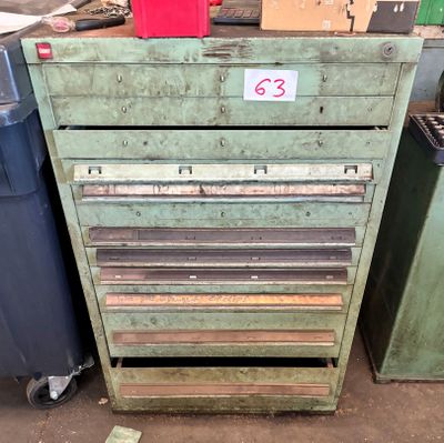 une vieille armoire à outils verte sur laquelle figure un numéro