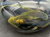 a black and yellow glass paperweight on a table