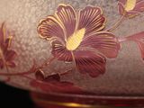 a glass bowl with flowers on it on a table