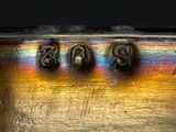 a close up of a silver plate with numbers on it