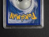 a pokemon card in a plastic holder on a table
