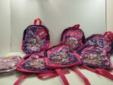 three pink backpacks and a pink backpack are sitting on a counter