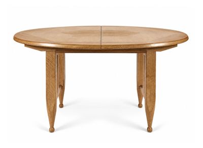 a wooden table with two leaves on the top