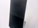 a cell phone that is sitting on top of a stand