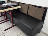 a couch and a table with a laptop on top of it