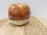a small vase sitting on top of a wooden table