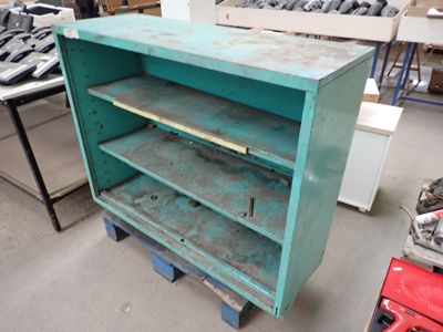 a green cabinet with a shelf on top of it