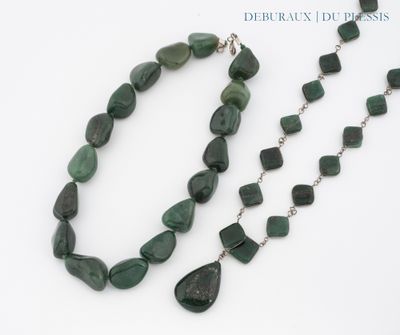 collier avec des pierres vertes et une chaîne en argent sur un fond blanc