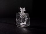 a clear glass bottle with a crown on top of it