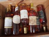 many bottles of wine sitting in a wooden box