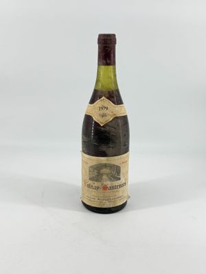 an old bottle of wine sitting on top of a white table