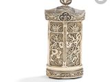 an ornate silver box with a bird on top of it