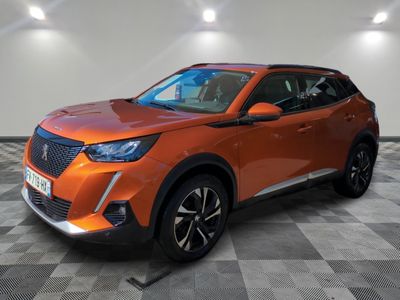 the orange suv is parked on a checkered tile floor
