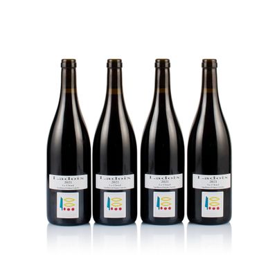 three bottles of wine are lined up on a white surface