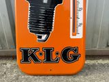 a sign that says klg on it in front of a building