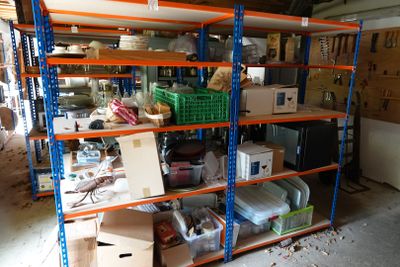 many boxes and boxes on the shelves in the garage