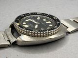 a watch that is sitting on a metal bracelet