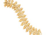 a close up of a gold bracelet on a white background