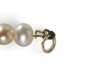 two pearl earrings on a white background with a gold clasp