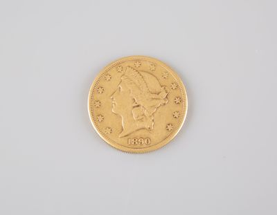 a close up of a gold coin on a white surface