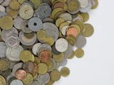 a pile of coins sitting on a white surface