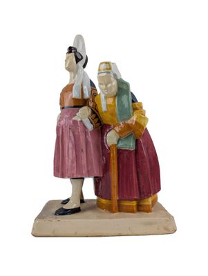 figurine of a man and a woman sitting on a bench