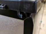 a close up of a metal table with a black top